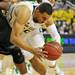 Michigan junior Jordan Morgan attempts to keep control of the ball as he loses his footing during the second half of an NIT Season Tip-Off game at Crisler Center on Tuesday. Melanie Maxwell I AnnArbor.com